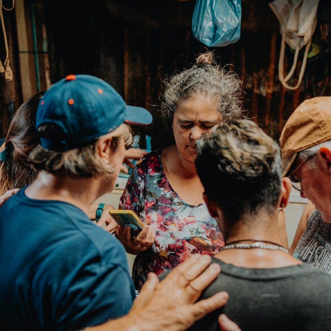 a group of people standing around each other